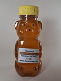 Honey bear bottle with a label on a white background
