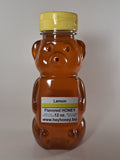 Bee-shaped lemon honey bottle on a white background