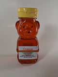 Orange honey bottle with a label on a white background