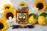 Turkish Sunflower Limoncello honey jar surrounded by sunflowers, fresh orchids, fresh lemons, and vanilla bean pods on marble — infused Turkish raw honey | HeyHoney.biz
